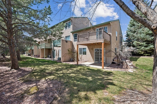 6087 Colony Cir, Colorado Springs, CO 80919 - rear view of house featuring stucco siding, a patio area, and a yard