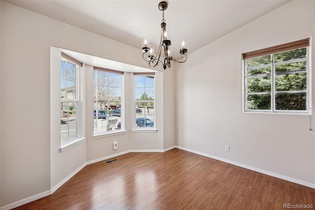 6087 Colony Cir, Colorado Springs, CO 80919 - spare room with a chandelier, wood finished floors, baseboards, and lofted ceiling