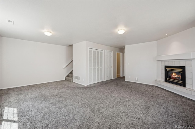 6087 Colony Cir, Colorado Springs, CO 80919 - unfurnished living room with carpet, stairs, a fireplace, and baseboards
