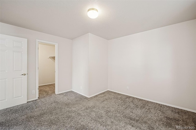 6087 Colony Cir, Colorado Springs, CO 80919 - unfurnished bedroom featuring carpet, a walk in closet, and baseboards