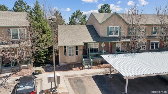 6087 Colony Cir, Colorado Springs, CO 80919 - view of front of property featuring uncovered parking, a chimney, stucco siding, metal roof, and roof with shingles