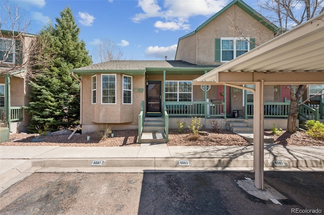 6087 Colony Cir, Colorado Springs, CO 80919 - view of front facade with uncovered parking, covered porch, and stucco siding