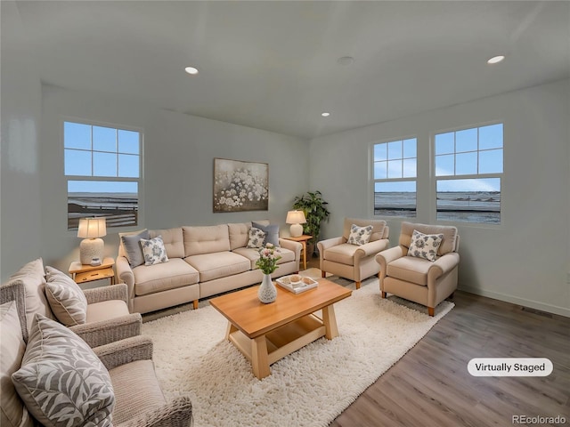 living room featuring a water view and hardwood / wood-style floors