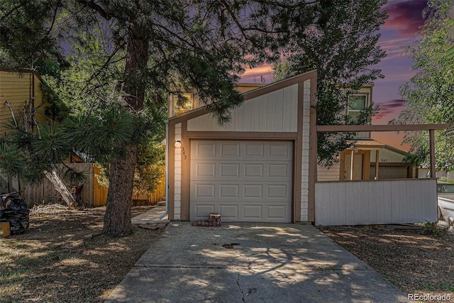 view of garage at dusk