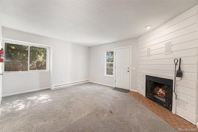 unfurnished living room with a baseboard radiator, carpet flooring, and a healthy amount of sunlight