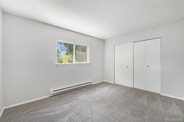 unfurnished bedroom with a closet, a textured ceiling, and a baseboard heating unit