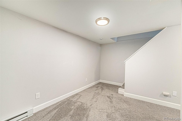 basement with a baseboard heating unit and light carpet