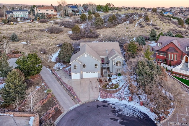 aerial view at dusk featuring a residential view