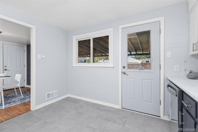 entryway with plenty of natural light and light tile patterned floors