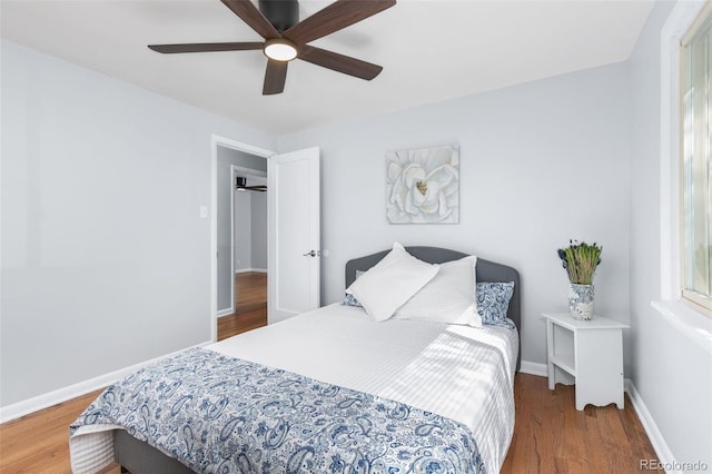 bedroom with dark wood-type flooring and ceiling fan