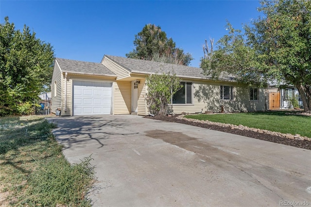 single story home with a garage and a front lawn