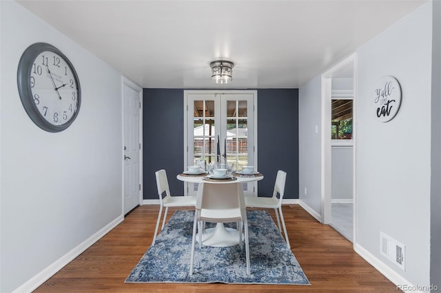 dining area featuring dark hardwood / wood-style flooring and french doors