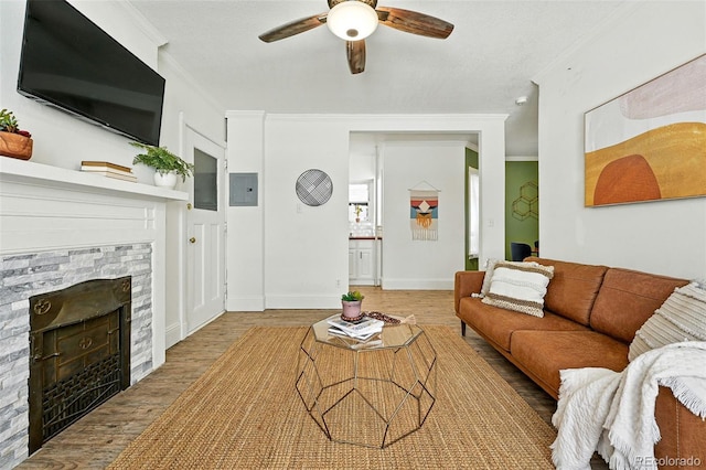 1137 N Sherman St Unit 17, Denver, CO 80203 - living area with crown molding, wood finished floors, a ceiling fan, a fireplace, and electric panel