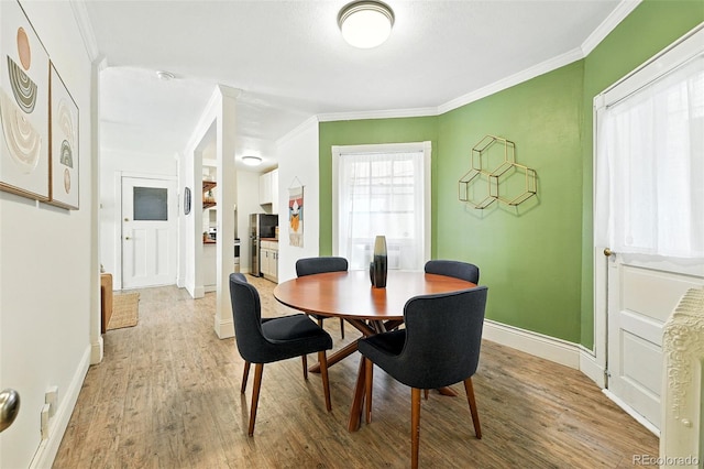 1137 N Sherman St Unit 17, Denver, CO 80203 - dining space with ornamental molding and wood finished floors