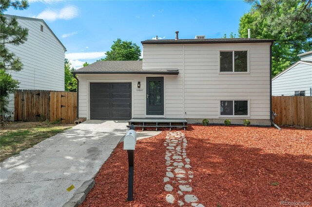 10687 W 107th Ave, Broomfield, CO 80021 - split level home featuring an attached garage and driveway