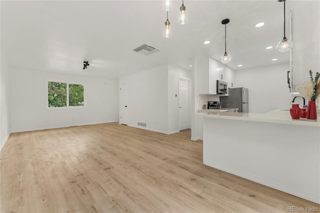 10687 W 107th Ave, Broomfield, CO 80021 - unfurnished living room with light wood-style flooring and recessed lighting