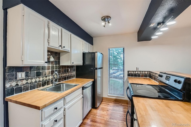 695 Manhattan Dr Unit 109, Boulder, CO 80303 - kitchen with wood counters, a sink, stainless steel appliances, and tasteful backsplash