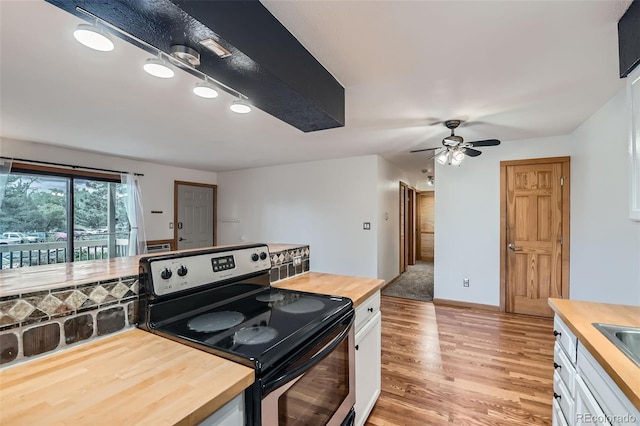 695 Manhattan Dr Unit 109, Boulder, CO 80303 - kitchen with stainless steel electric range oven, wooden counters, light wood-type flooring, white cabinets, and a ceiling fan