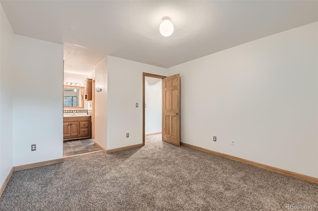 695 Manhattan Dr Unit 109, Boulder, CO 80303 - unfurnished bedroom featuring light colored carpet, baseboards, connected bathroom, and a sink