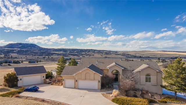 view of front of home with a mountain view and a garage