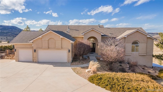 single story home featuring a garage and a mountain view