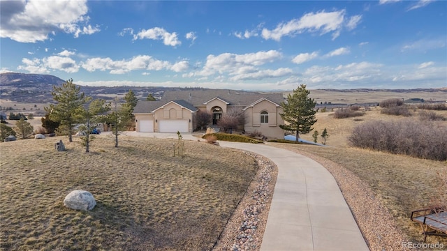 view of front of house featuring a garage and a mountain view