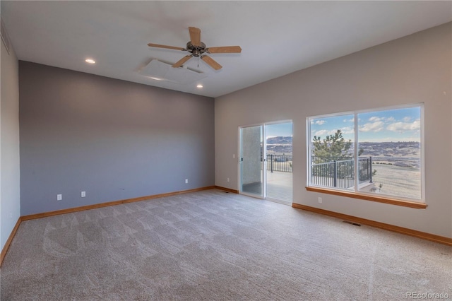 carpeted empty room featuring ceiling fan