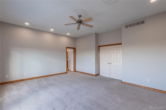 unfurnished room with light colored carpet and ceiling fan