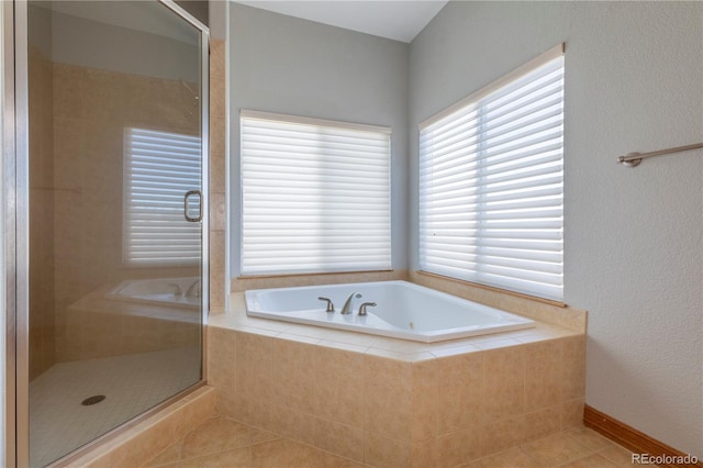 bathroom featuring shower with separate bathtub and tile floors