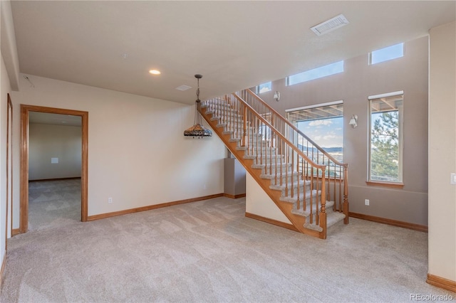 unfurnished living room featuring light carpet