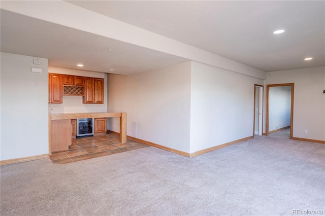 unfurnished living room with light tile floors and beverage cooler