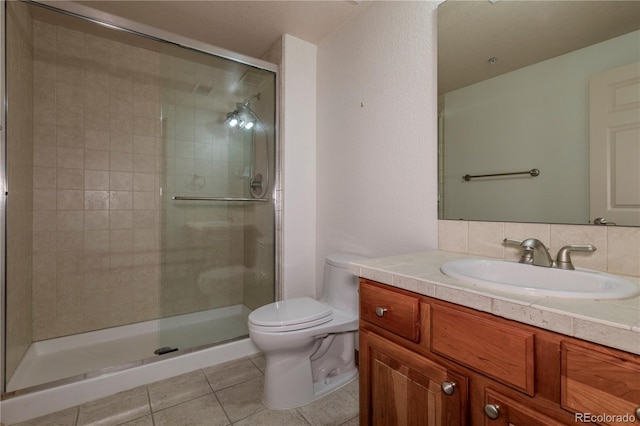 bathroom with vanity with extensive cabinet space, an enclosed shower, tile flooring, tasteful backsplash, and toilet