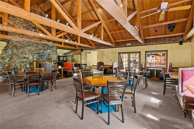 dining space featuring ceiling fan, wood ceiling, beam ceiling, high vaulted ceiling, and carpet floors