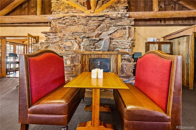 dining area featuring vaulted ceiling with beams and carpet