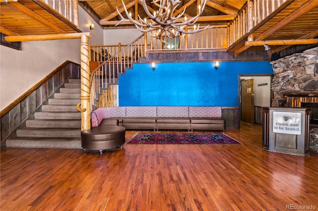 unfurnished living room featuring high vaulted ceiling, wooden ceiling, and hardwood / wood-style floors