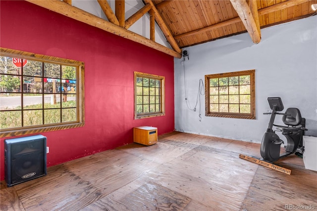 unfurnished room with high vaulted ceiling, wood ceiling, beamed ceiling, and a healthy amount of sunlight