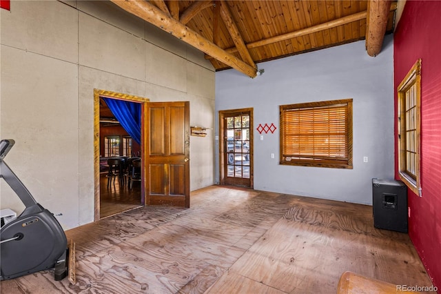 interior space with wooden ceiling and vaulted ceiling with beams