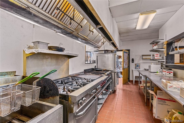 kitchen with high end stainless steel range oven and tile patterned floors