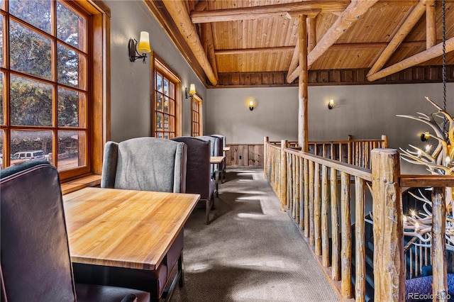 home office featuring vaulted ceiling with beams, wooden walls, carpet, and wooden ceiling