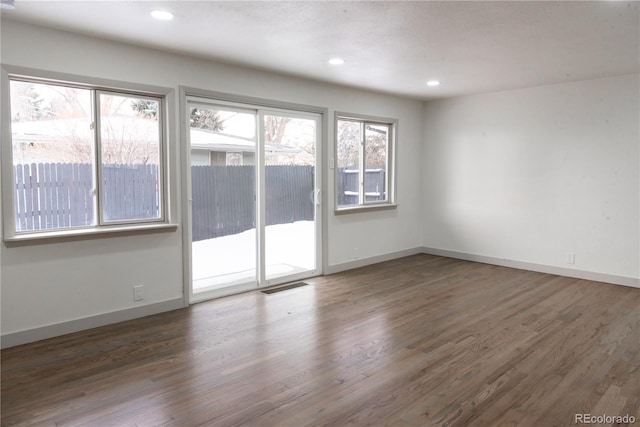 spare room featuring dark hardwood / wood-style floors