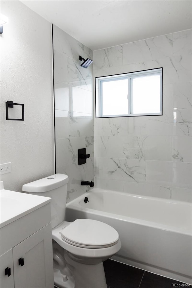 full bathroom with tile patterned floors, toilet, vanity, and tiled shower / bath