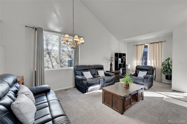 living room with high vaulted ceiling, light colored carpet, and a chandelier