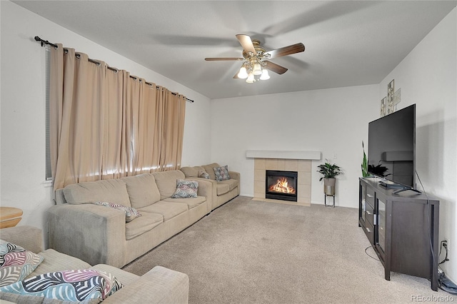 living room with ceiling fan, light colored carpet, and a fireplace