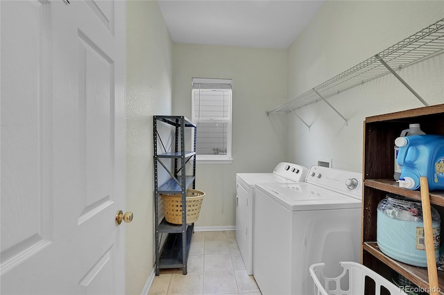 laundry area with light tile patterned floors and washer and dryer