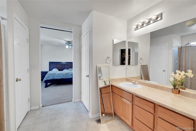 bathroom with vanity, a textured ceiling, and ceiling fan