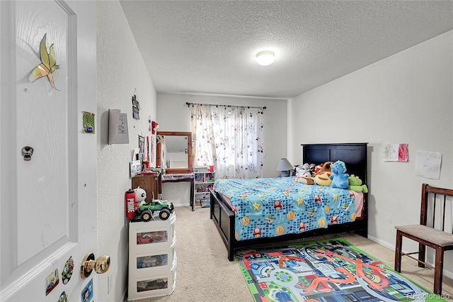 bedroom with carpet floors and a textured ceiling