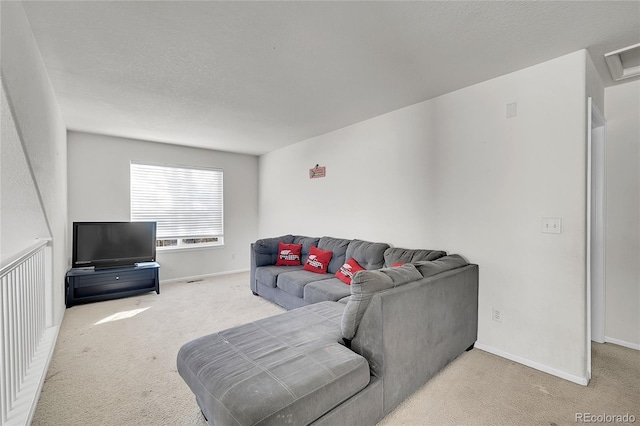 carpeted living room featuring a textured ceiling