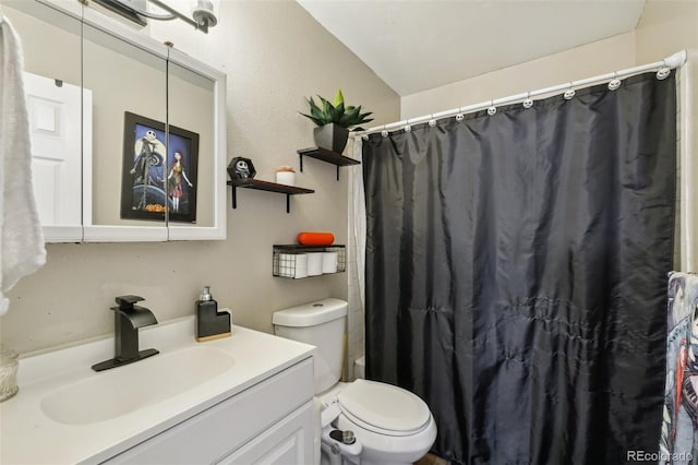 bathroom with toilet, vanity, and curtained shower