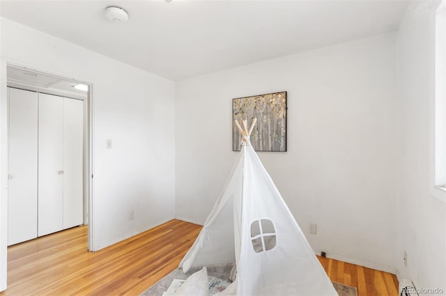 game room with light hardwood / wood-style floors