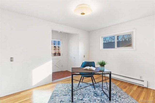 home office featuring hardwood / wood-style flooring and a baseboard heating unit